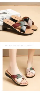 Detailed visual of women's cowhide leather flat sandals featuring leaf-shaped cross straps