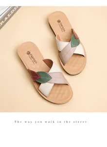 Detailed view of women's multi-color leather flat sandals with unique leaf design