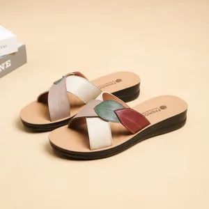 Women's genuine cowhide flat sandals with leaf-shaped cross straps in a casual summer style