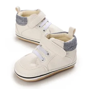 Detailed view of cream baby high-top walker shoes with non-slip rubber soles and straps
