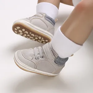 Close-up of grey high-top baby walking shoes with soft non-slip sole and strap