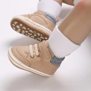 Macro view of khaki baby walking shoes featuring soft soles and a convenient velcro strap.