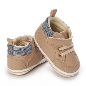 Close-up of soft brown high-top baby walking shoes with comfortable denim ankle details.