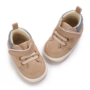 Detailed view of the beige faux leather high-top baby walking shoes with soft soles