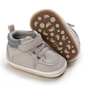 Macro view of baby high-top walking shoes showing grey leather and anti-slip sole
