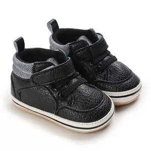 Black high-top baby walker shoes with textured rubber sole and easy velcro strap closure