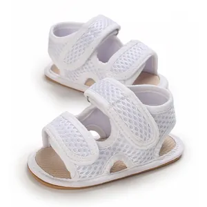 Macro view showing the breathable mesh detail of white soft-soled infant sandals.