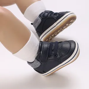 Detail of navy blue high-top baby walking shoes with rubber sole and velcro strap.