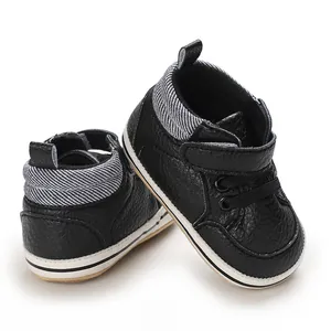 Detailed view of black baby high-top walking shoes with striped collar and rubber sole