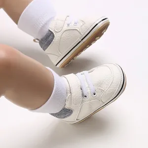 Close-up detail of white baby walking shoes with soft soles and secure Velcro closure straps
