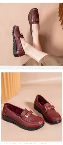 Detailed close-up of burgundy perforated leather loafers featuring a golden buckle.