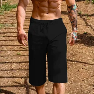 Detailed view of men's black breathable linen cotton cropped leisure shorts worn outdoors