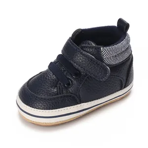 Macro shot of navy blue high-top baby walker shoes featuring premium leather texture