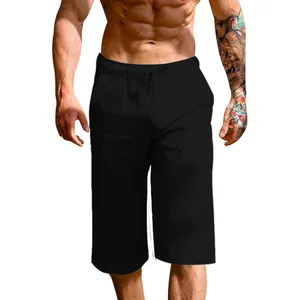Detail view of men's loose linen cotton cropped pants in black for casual summer wear