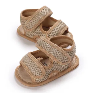 Close-up detail of breathable mesh baby sandals with soft soles and tan straps.