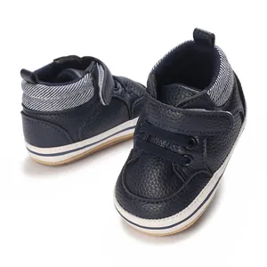 Close-up detail of navy blue high-top baby walking shoes with rubber soles.