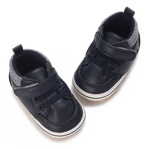 Detailed view of navy blue high-top baby pre-walker shoes with soft rubber soles.