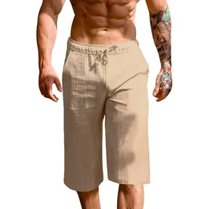 Detail showing texture and drawstring of men's loose linen cropped pants.