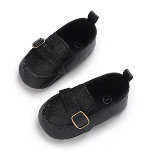 Top view detail of black faux leather infant soft-sole walking shoes with buckle strap