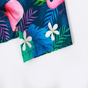 Macro detail of tropical flamingo print and stitching on men's beach shirt