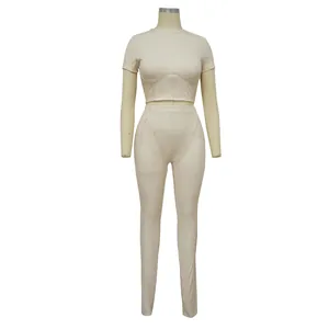 Detailed view of beige ribbed fabric and seam construction on athletic two-piece set