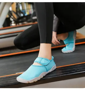 Action shot close-up of breathable blue aqua shoes with velcro strap being worn on a treadmill