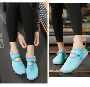 Close-up detail view of light blue mesh aqua shoes with adjustable velcro straps for women