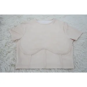 Detailed macro view of cream ribbed short sleeve crop top featuring corset style chest seams