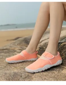 Side detail of orange breathable mesh water shoes for beach and outdoor activities.