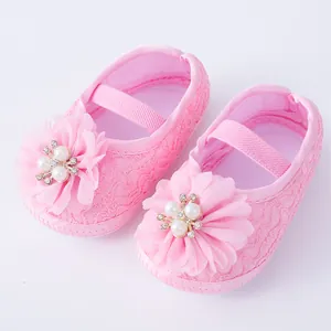 Close-up detail of soft sole pink baby princess shoes with large floral pearl accents