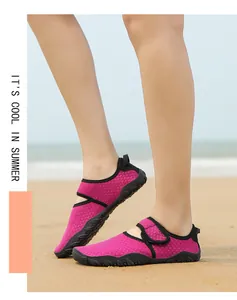 Detailed view of rose pink breathable mesh water shoes for women on a sunny sandy beach