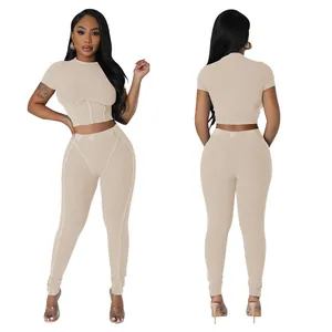 Front and back view of women's beige ribbed crop top and high-waisted leggings set