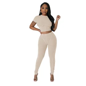 Macro view showing the ribbed texture of this beige two-piece crop top and leggings set.