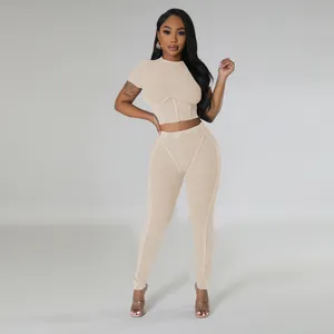 Full view of a beige ribbed two-piece set featuring a crop top and high-waisted leggings