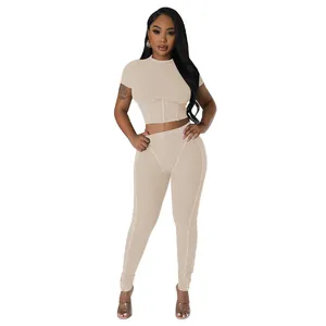 Sexy beige ribbed two-piece set featuring a short sleeve crop top and high waist leggings.