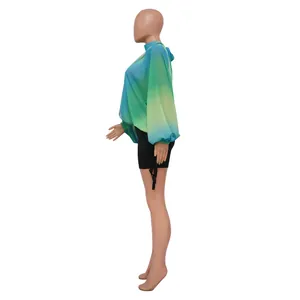 Vista laterale della camicetta in chiffon sfumato blu-verde con eleganti maniche a pipistrello