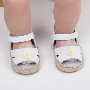 Vista detallada de zapatos de princesa blancos para bebé con suelas blandas y flores