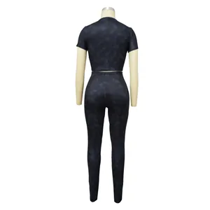 Back view of a ribbed two-piece sports set with short sleeve crop top and leggings