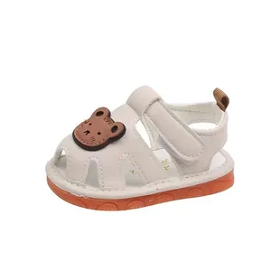 White baby sandals with cute bear patch and orange soft anti-slip sole for toddlers