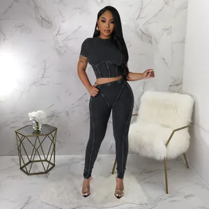 Detailed full-body shot of a grey ribbed two-piece workout set with corset-style stitching.