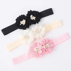 Set of three baby headbands with delicate fabric flowers in black cream and pink