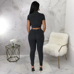Detailed back view of a slim-fit black ribbed two-piece set for women's sports
