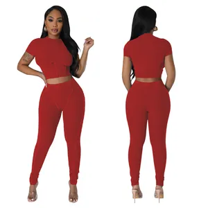 Detailed view of red ribbed two-piece activewear set featuring crop top and leggings