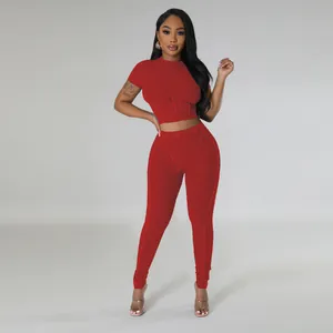 Close-up showing the ribbed knit texture of this red two-piece crop top and leggings set