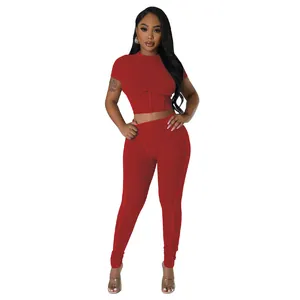 Detailed view of women's red ribbed two-piece athletic crop top and leggings set