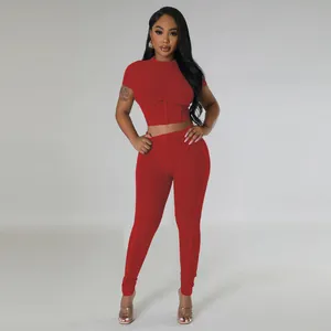 Frontal view of women's red ribbed two-piece set featuring a tight crop top and leggings