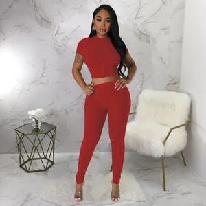 Red ribbed two-piece set featuring a short-sleeved crop top and matching leggings