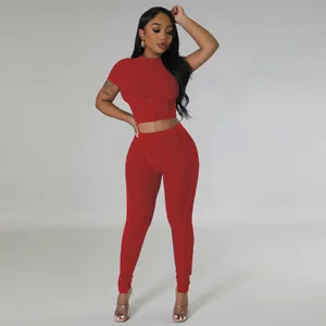 Detailed view of women's red ribbed two-piece set with corset style crop top and leggings