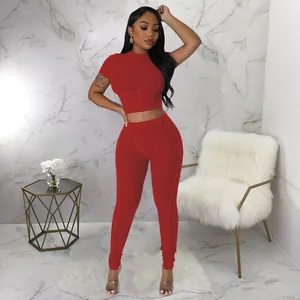 Detailed view of the red ribbed two-piece sports set featuring a tight short-sleeved top.