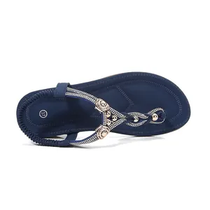 Navy blue flat sandals with rhinestones and bohemian style for summer comfort.